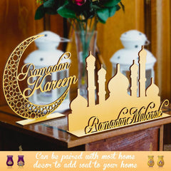 Decorative items with 'Ramadan Kareem' and 'Ramadan Mubarak' text on a wooden surface.