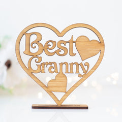 Wooden heart-shaped decoration with 'Best Granny' text on a white background