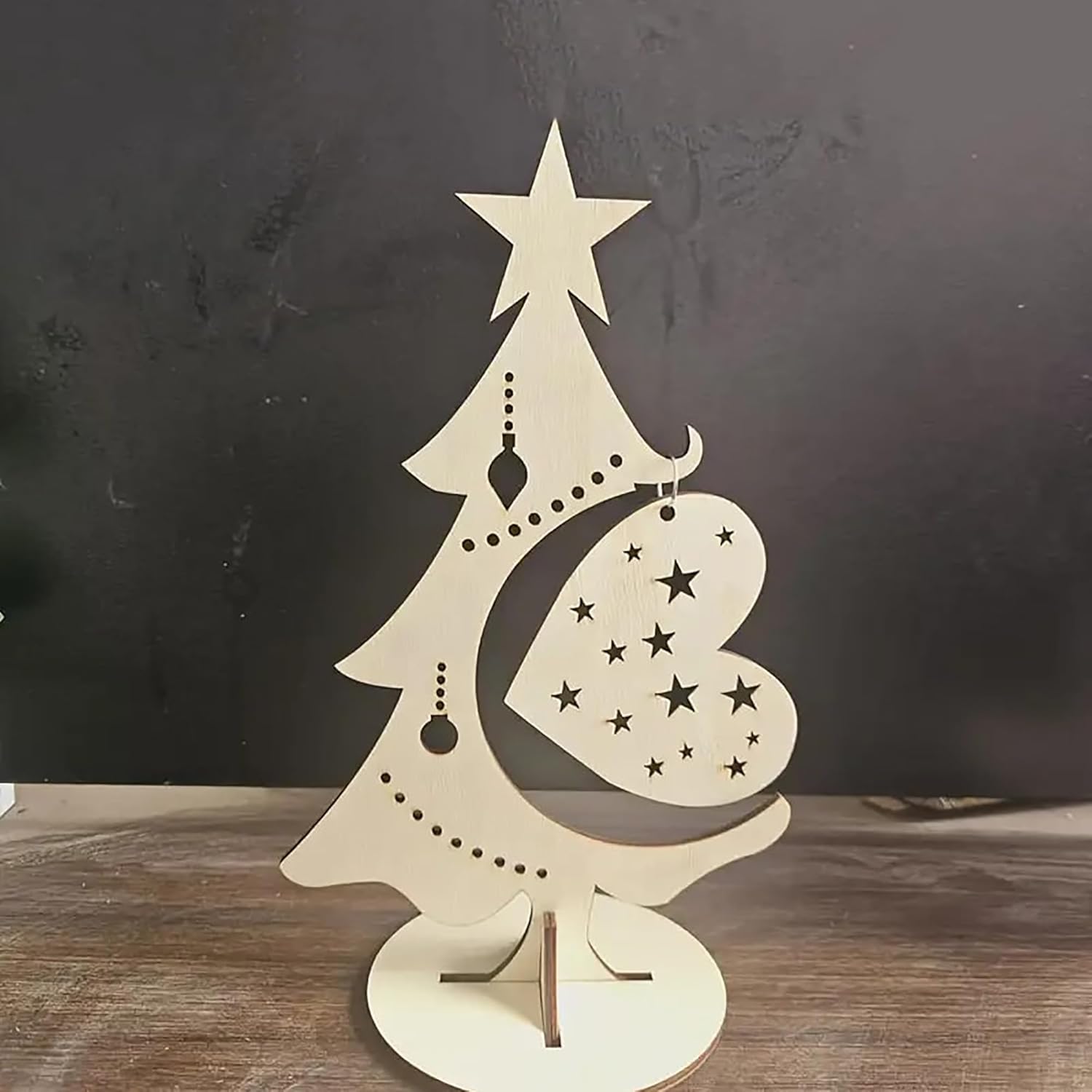 Decorative Christmas tree with heart ornament and star on a dark background
