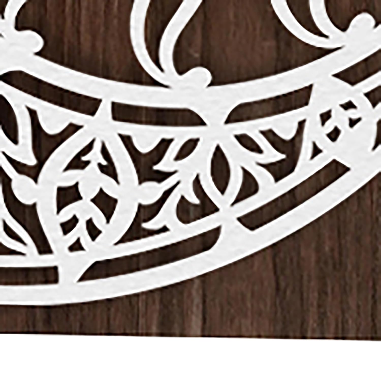 White decorative metal grille on a wooden background