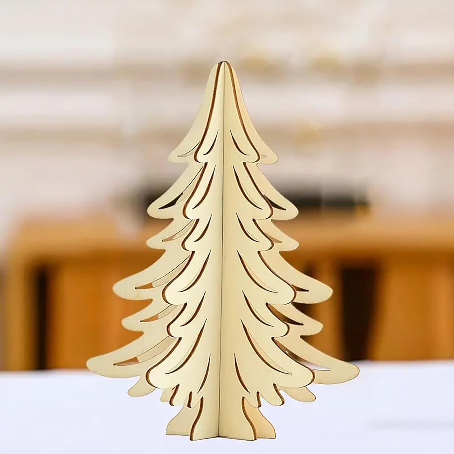 Wooden Christmas tree decoration on a white surface with a blurred background