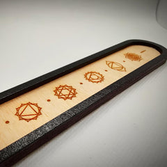 Wooden tray with geometric patterns on a white surface