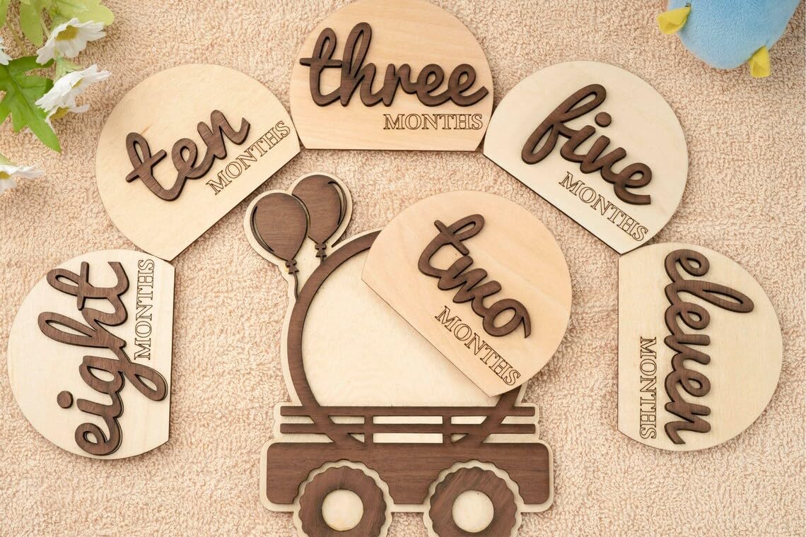Wooden milestone cards with numbers and 'one' written on a textured background