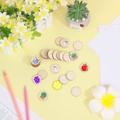 Wooden round stamps with various designs on a yellow surface with flowers and stationery items.