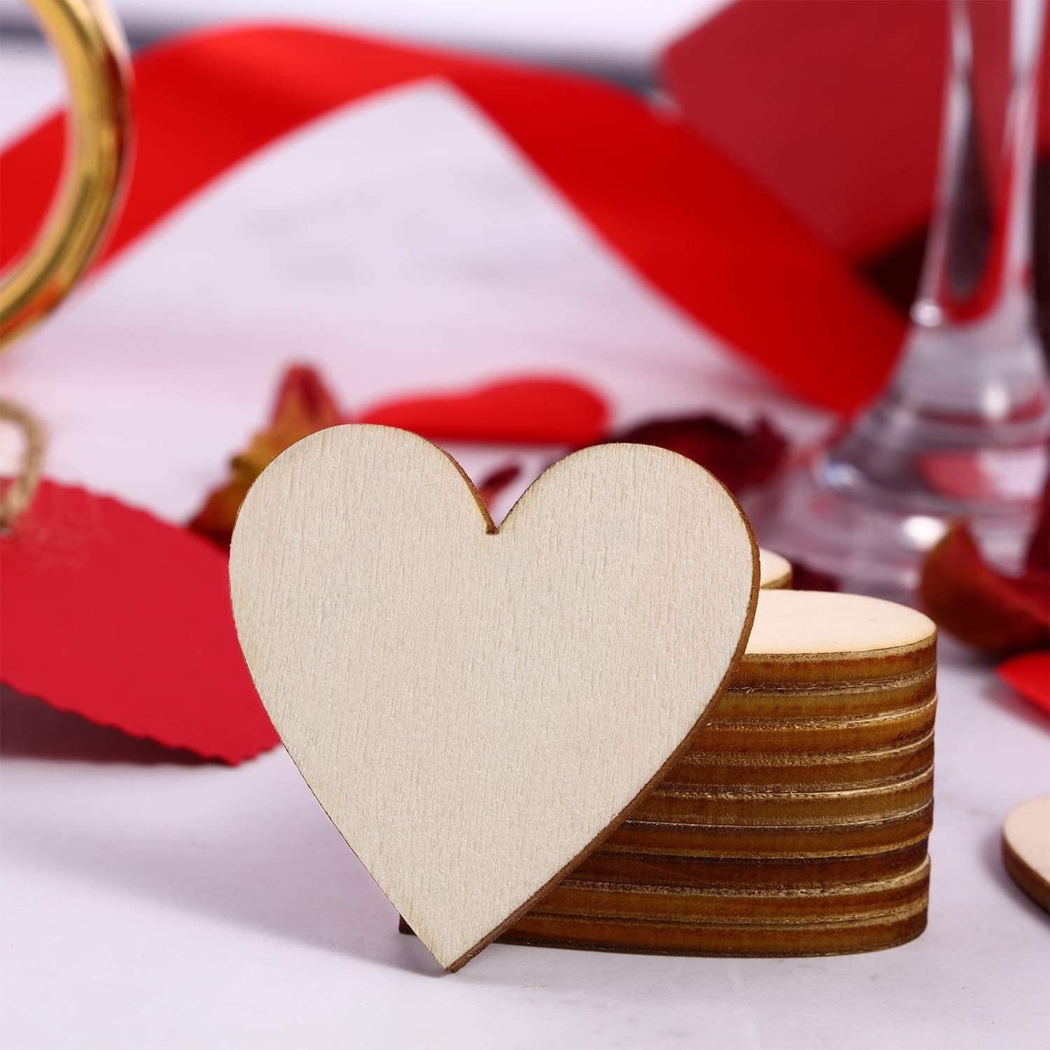 Stack of wooden heart-shaped coasters with a red and white striped fabric in the background.