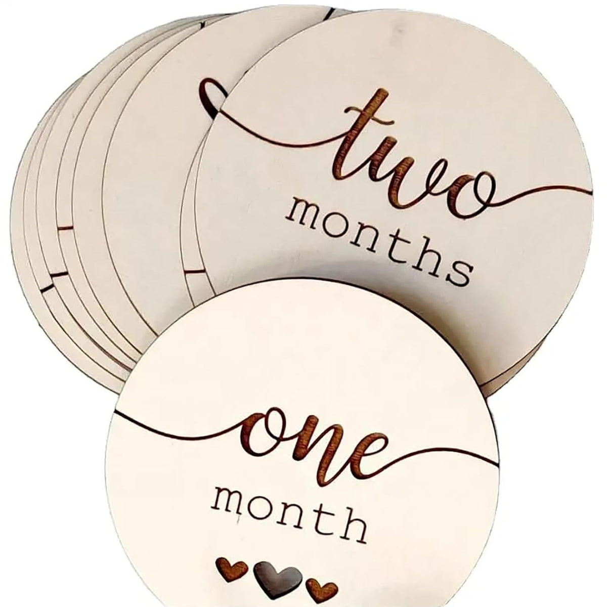 Round wooden discs with 'one month' and 'two months' text, used for baby milestone tracking.