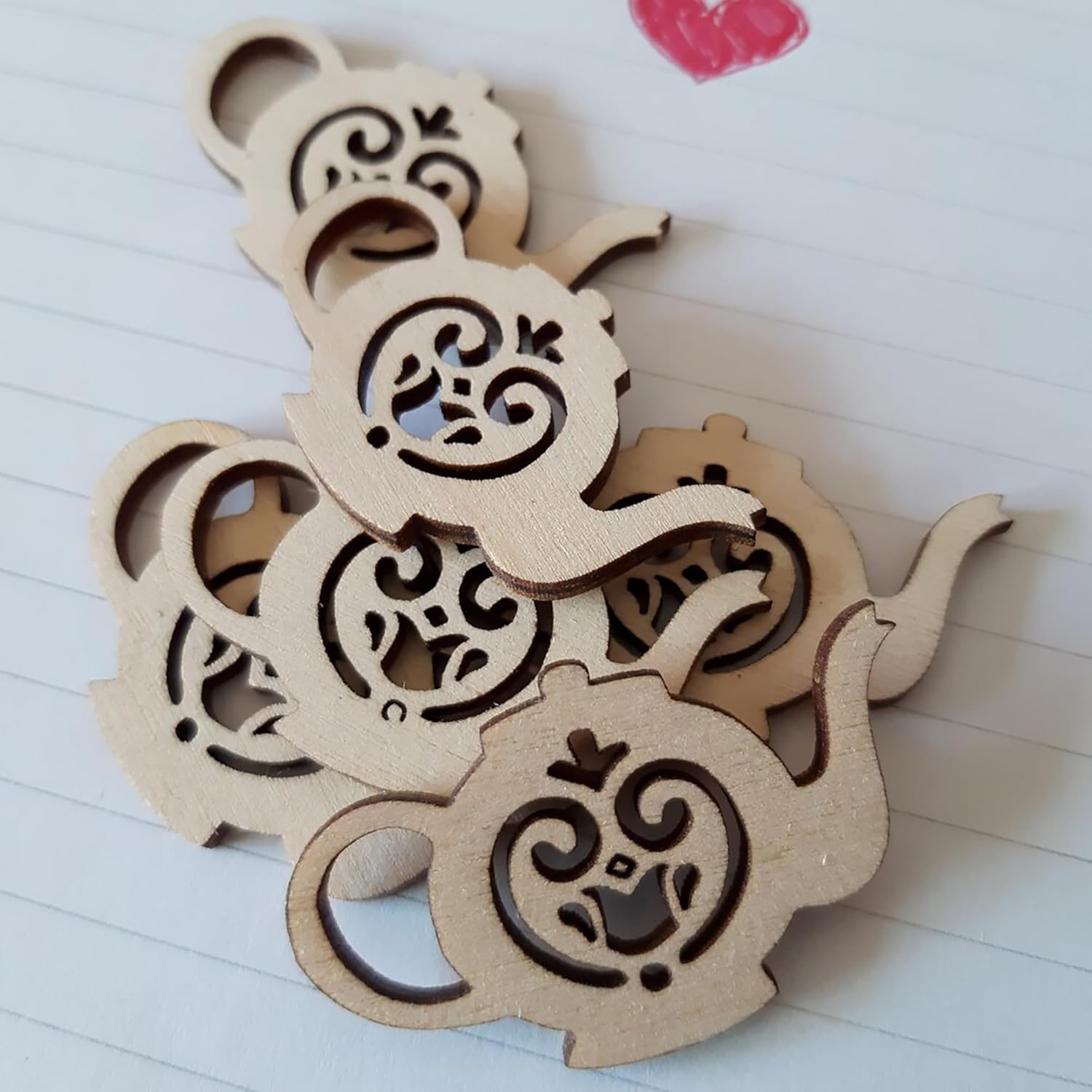 Wooden decorative piece with intricate cut-out patterns on a white surface