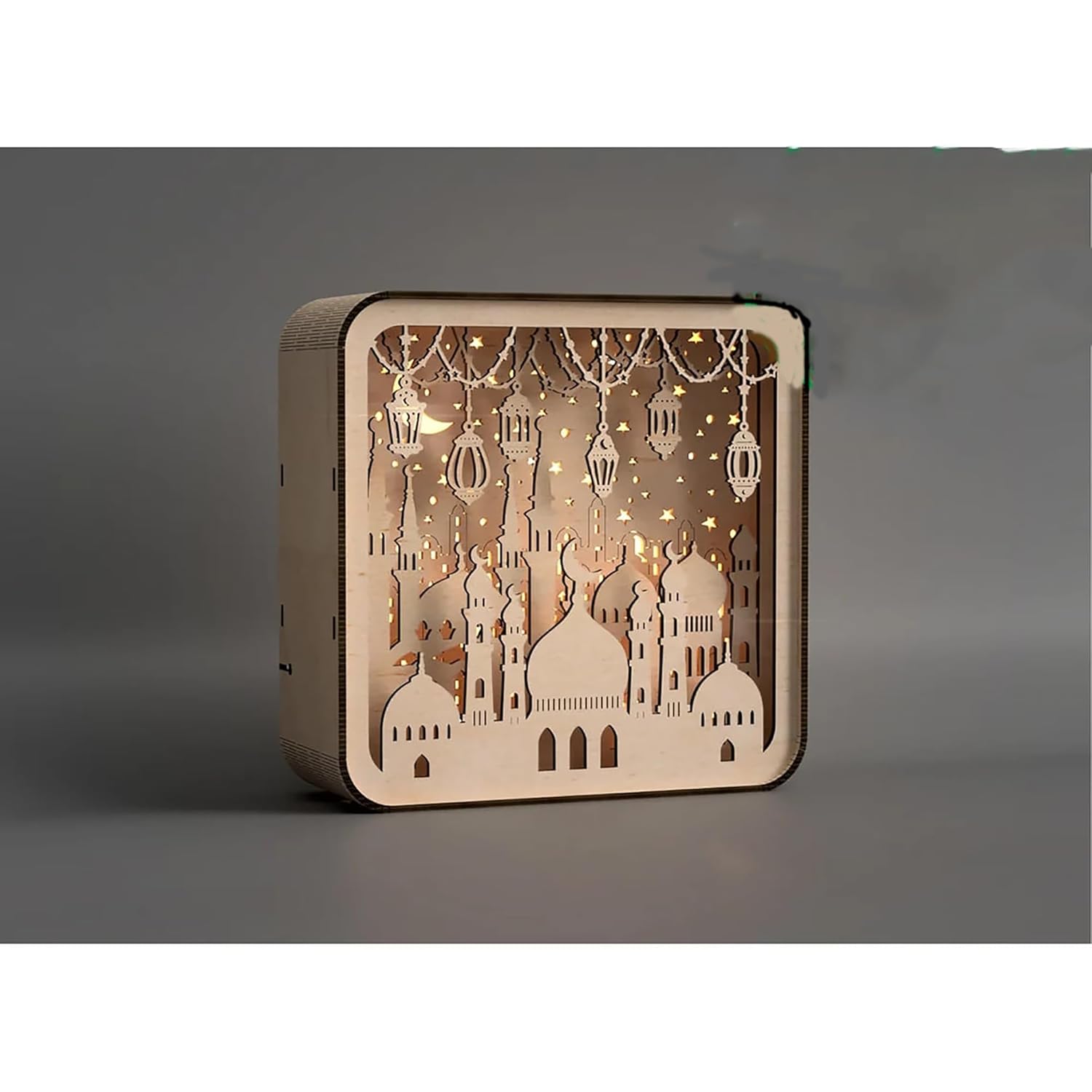 Wooden decorative box with cut-out designs of buildings and lanterns on a gray background