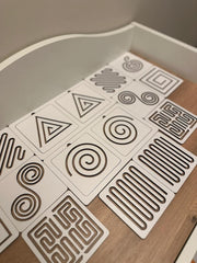 Set of geometric patterned cards on a wooden surface