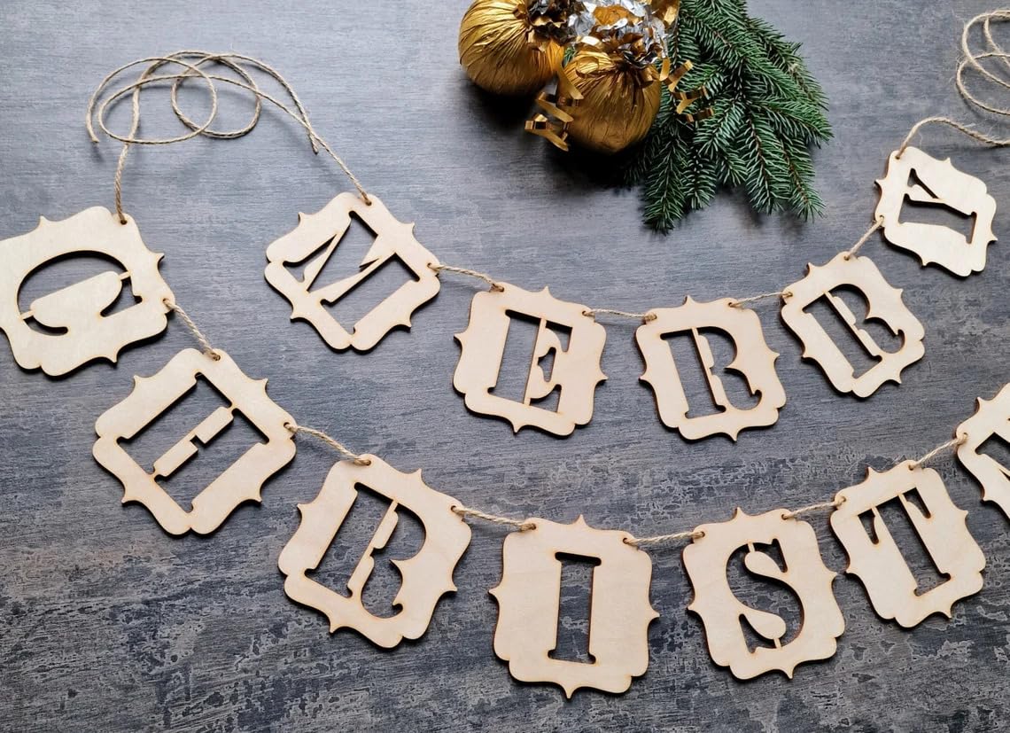 Decorative 'Merry Christmas' banner on a textured surface with gold ornaments and greenery.