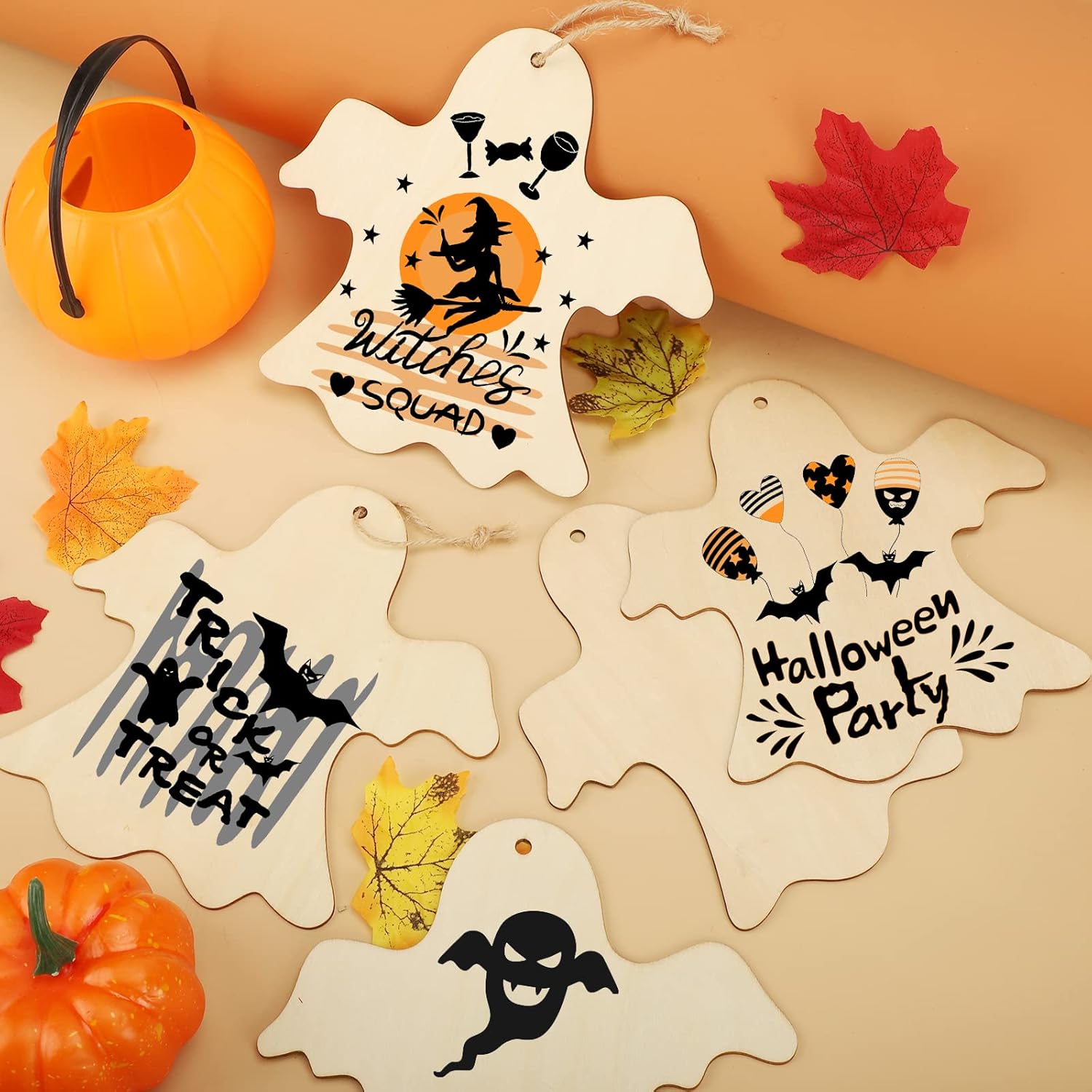 Halloween-themed wooden tags with decorative designs on a beige background with pumpkins and leaves.
