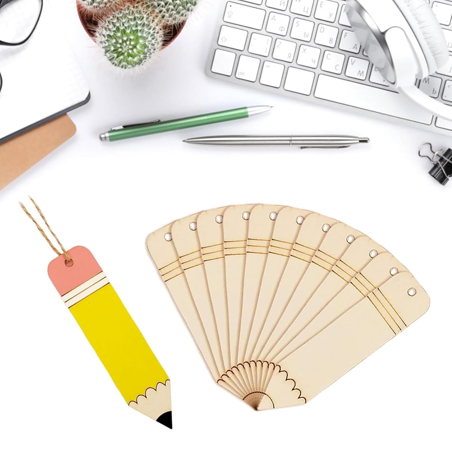Wooden fan and colorful pencil-shaped bookmark on a desk with office supplies.