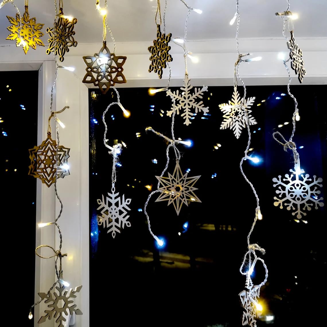 Decorative string lights with snowflake designs against a dark background