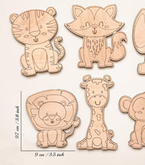 Set of wooden animal cutouts with measurements on a light background