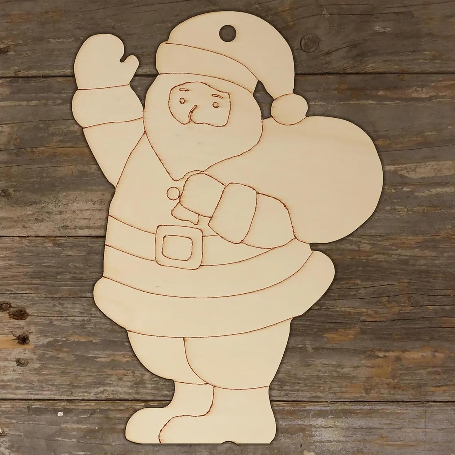 Wooden cutout of a Santa Claus figure on a wooden background