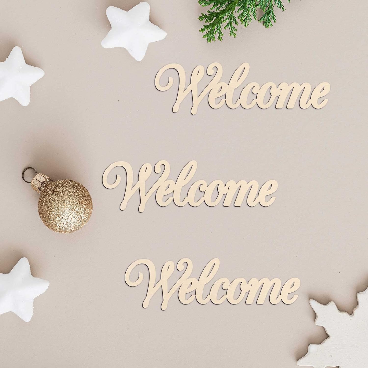 Wooden 'Welcome' signs with Christmas decorations on a beige background