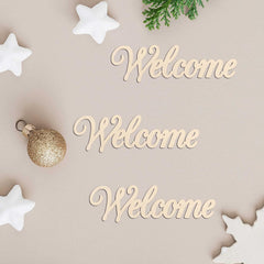 Wooden 'Welcome' signs with Christmas decorations on a beige background