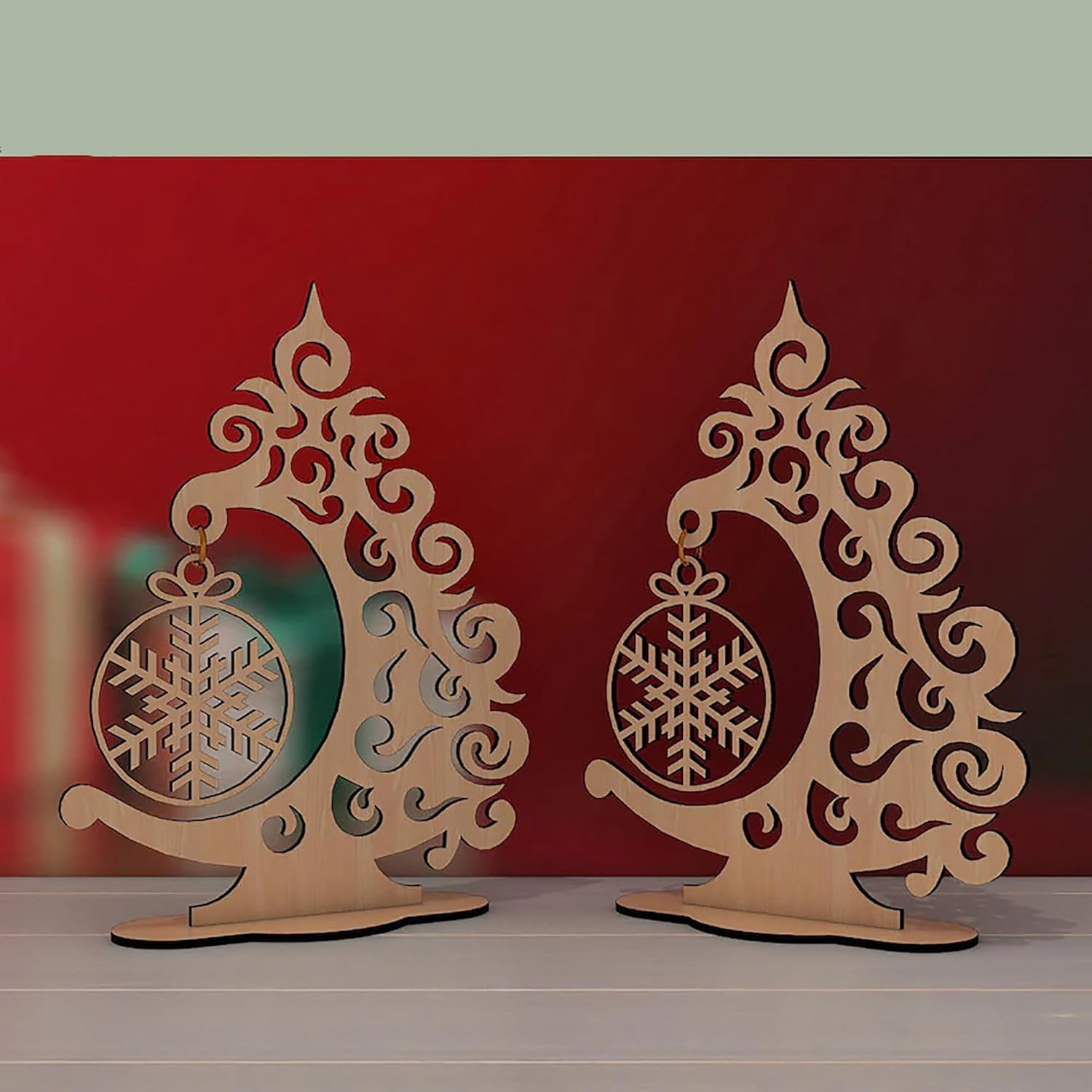 Two decorative wooden stands with snowflake designs on a red background