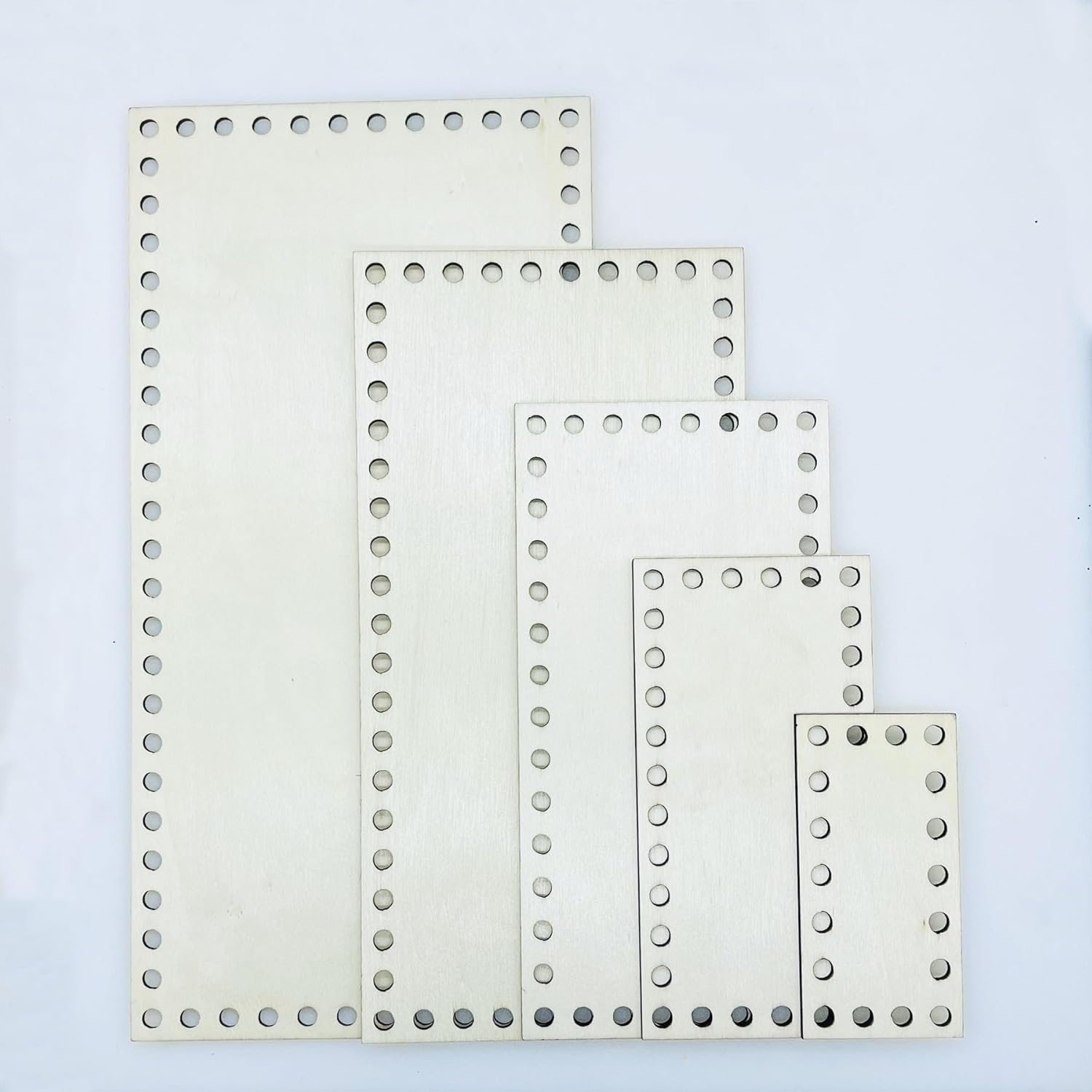 Set of white perforated sheets on a light blue background