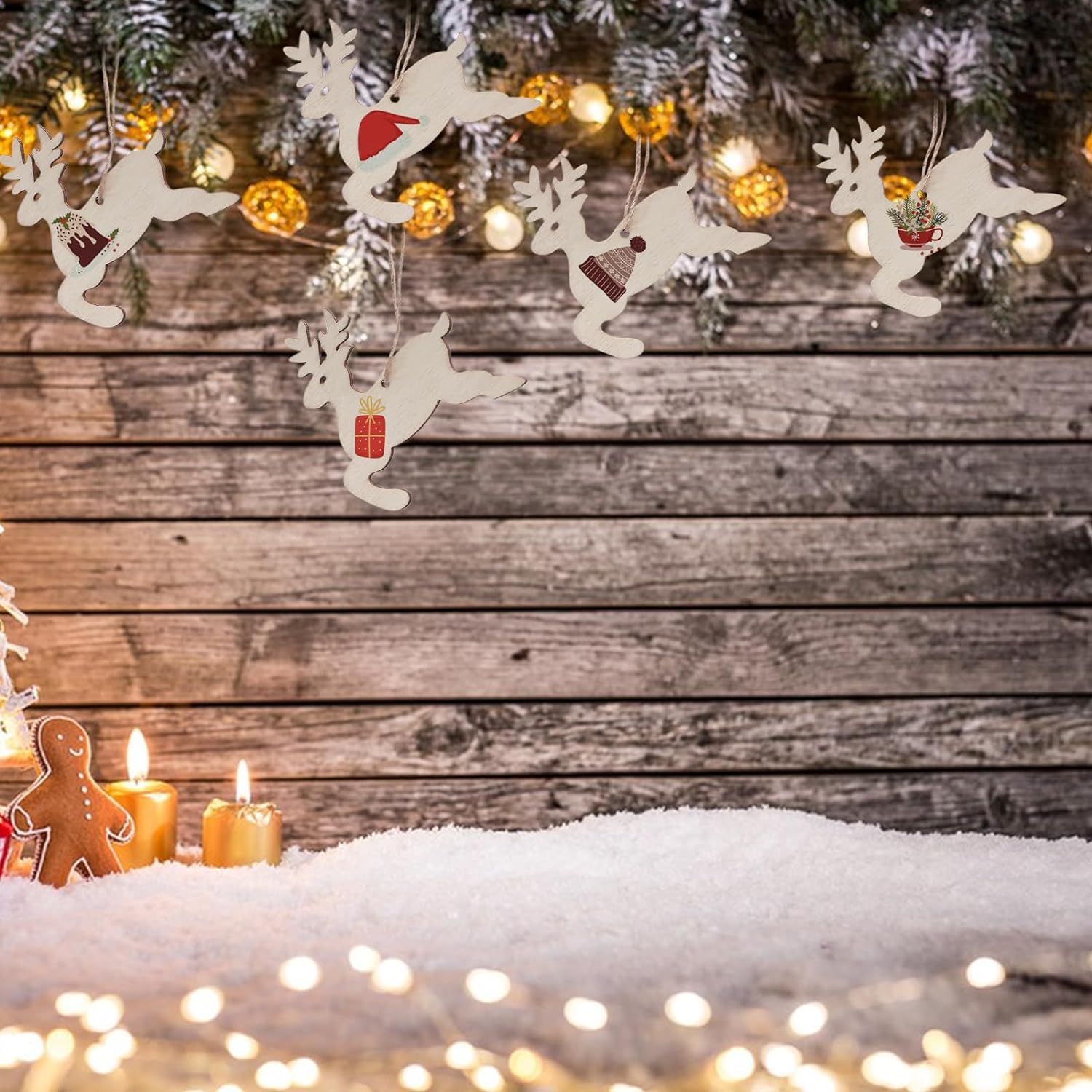 Decorative reindeer garland with Christmas lights and candles on a wooden background