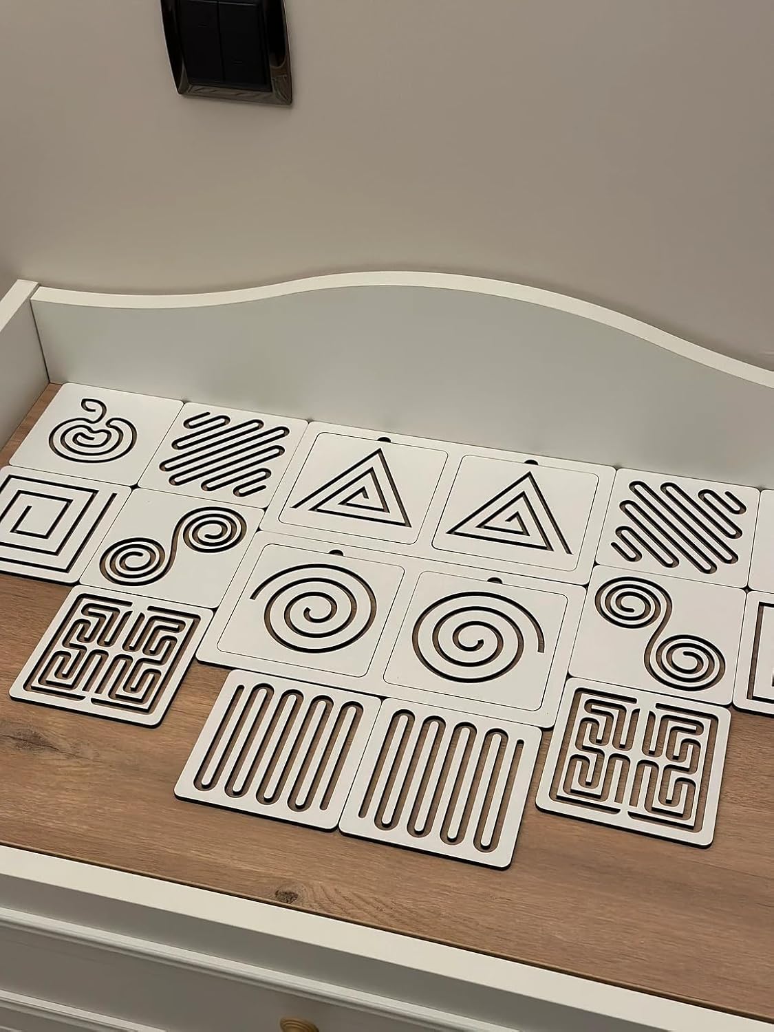 Set of geometric patterned tiles on a wooden surface