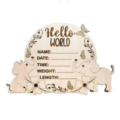 Wooden plaque with elephant designs and text fields for baby details on a white background