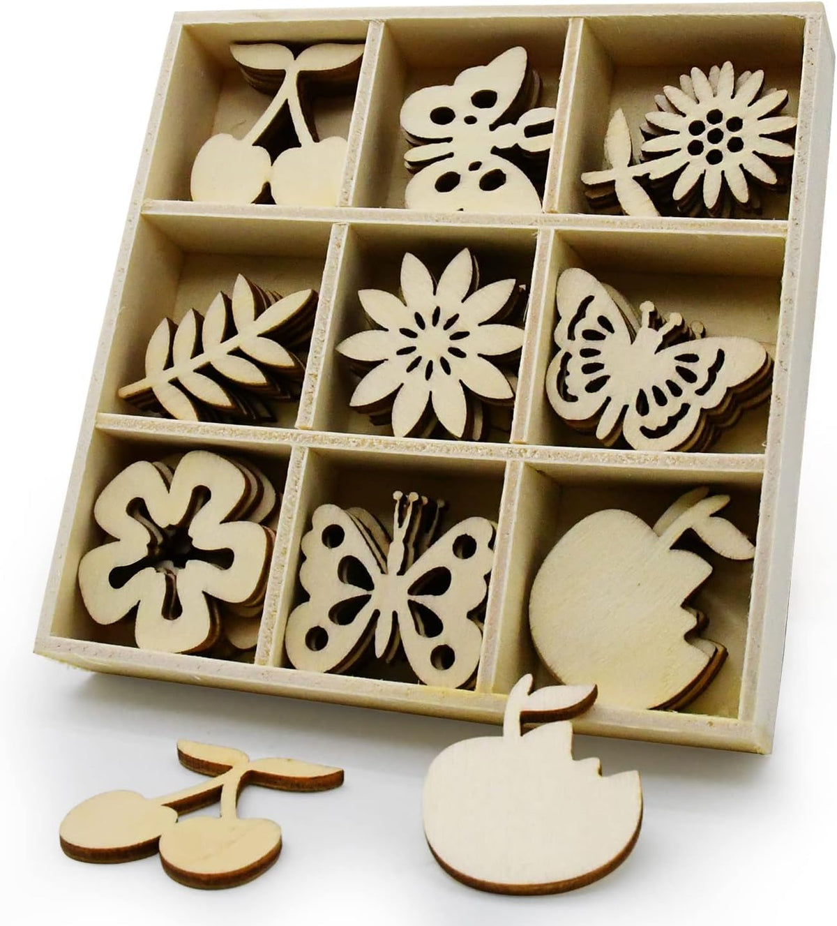 Set of wooden cutouts including flowers, butterflies, and cherries in a box on a white background