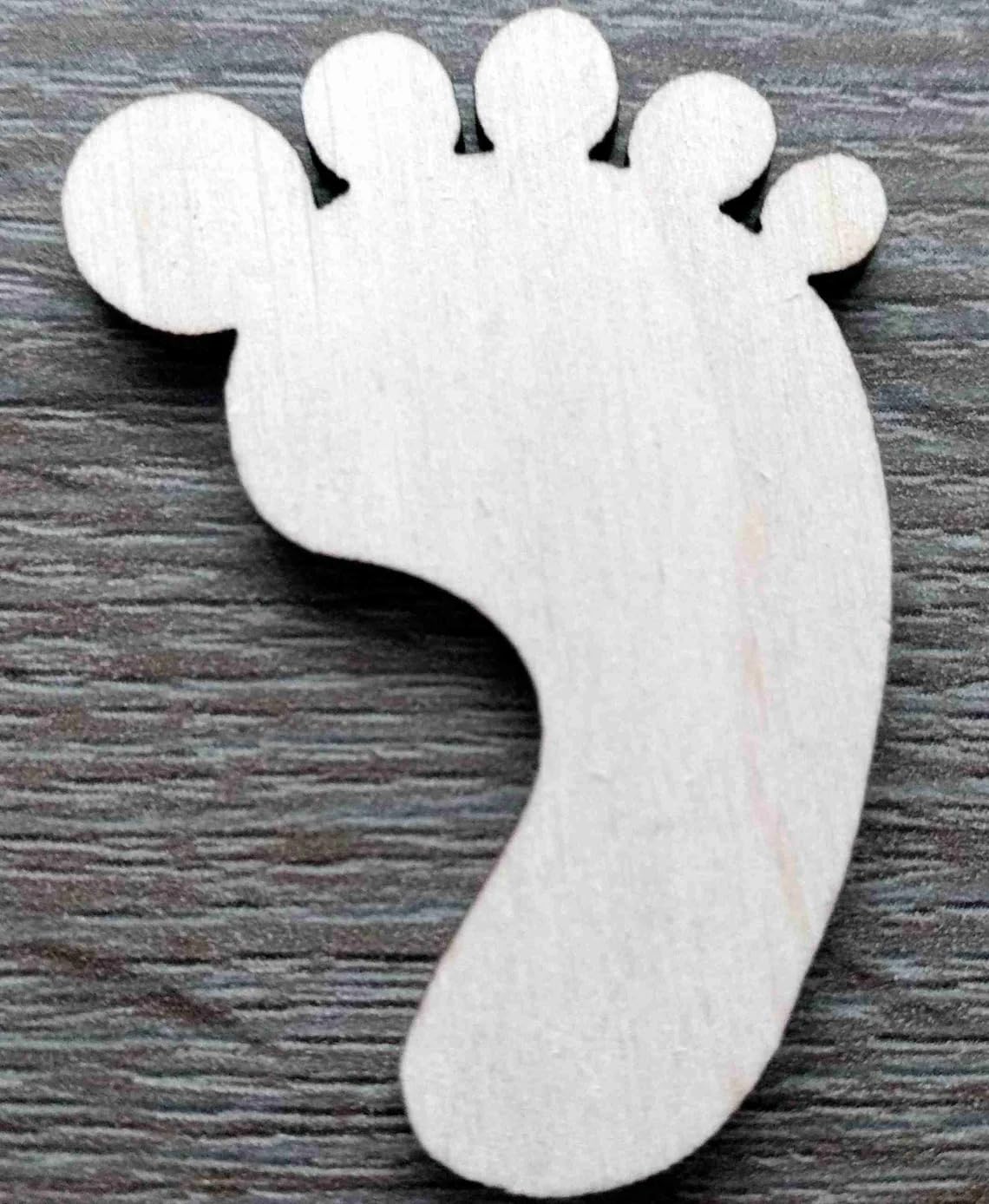 White foot-shaped object on a wooden surface