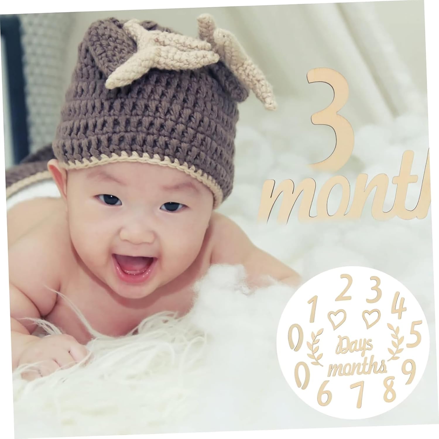 Baby wearing a crocheted hat with antlers, lying on a white blanket, with text indicating '3 months'.