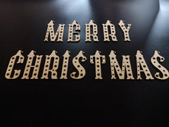 Wooden 'Merry Christmas' decoration on a black background