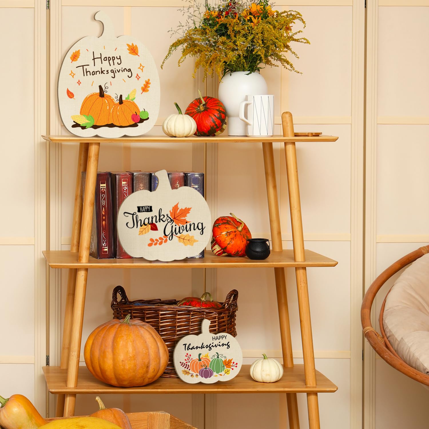 Wooden shelf with Thanksgiving-themed decor including pumpkins, plates, and a vase.