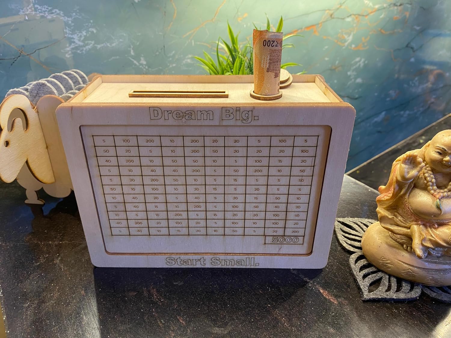Small wooden box with a printed design on a reflective surface with decorative elements.