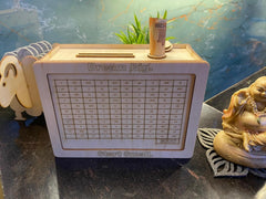 Small wooden box with a printed design on a reflective surface with decorative elements.