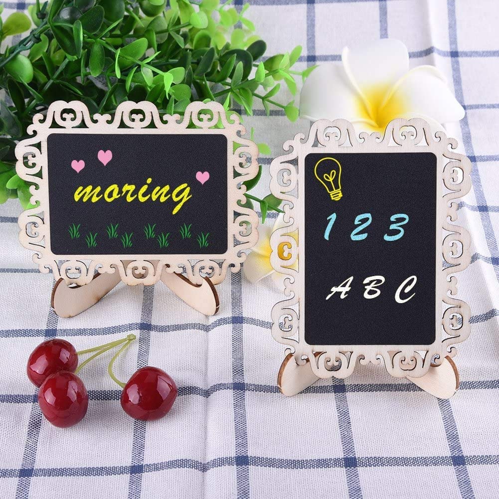 Two small blackboards with decorative frames on a checkered tablecloth with cherries and flowers.