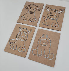 Four cardboard cutouts of animals on a white background