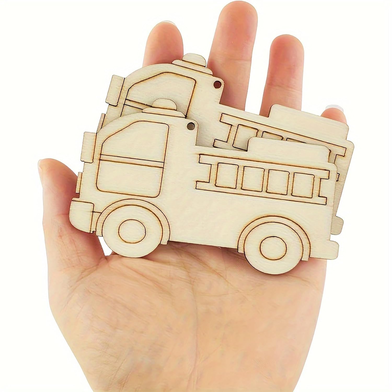 Wooden toy truck held in a hand against a white background