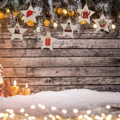 Decorative star-shaped ornaments with Christmas-themed illustrations on a wooden background with snow and lights.