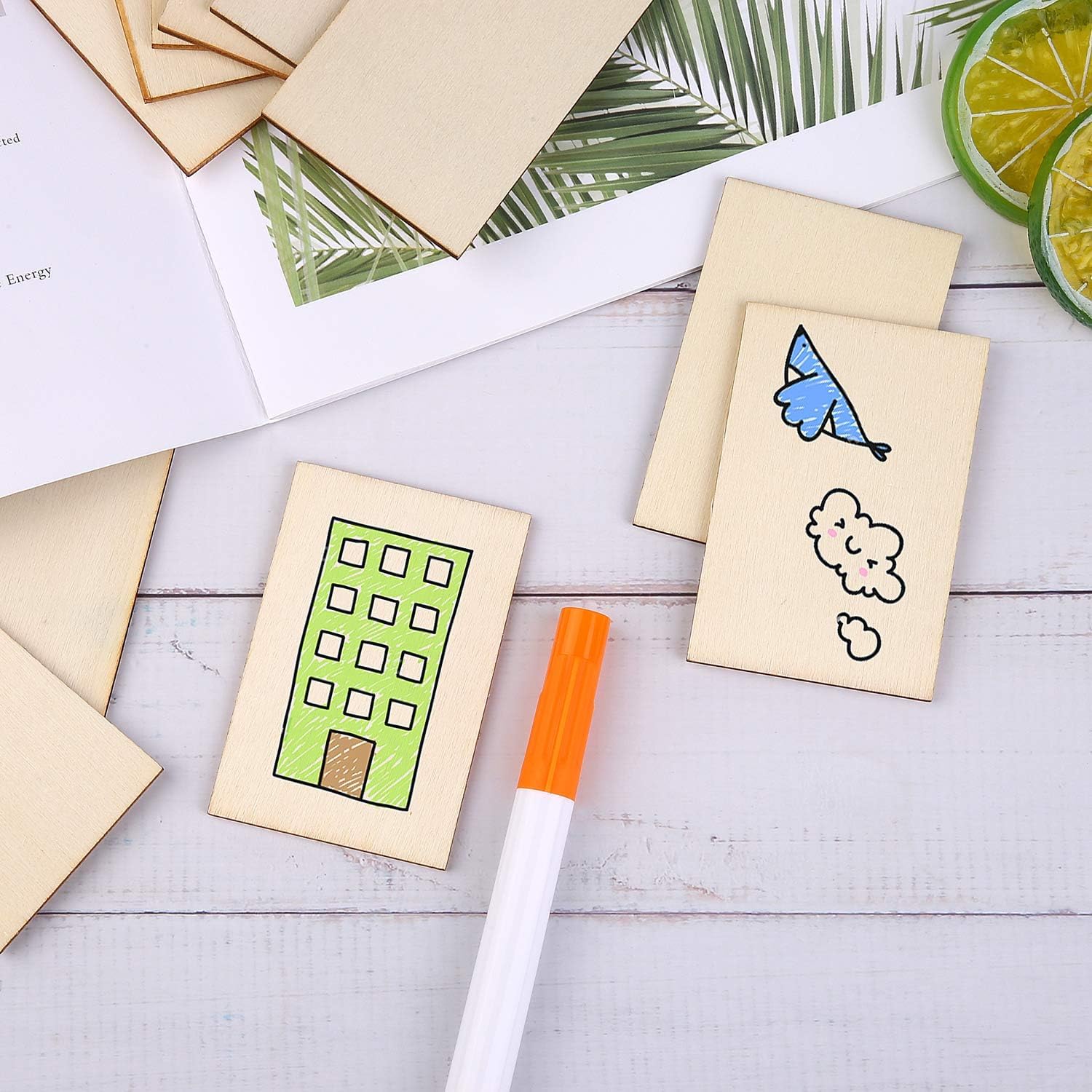 Set of wooden stamps with colorful designs on a white surface with a marker.