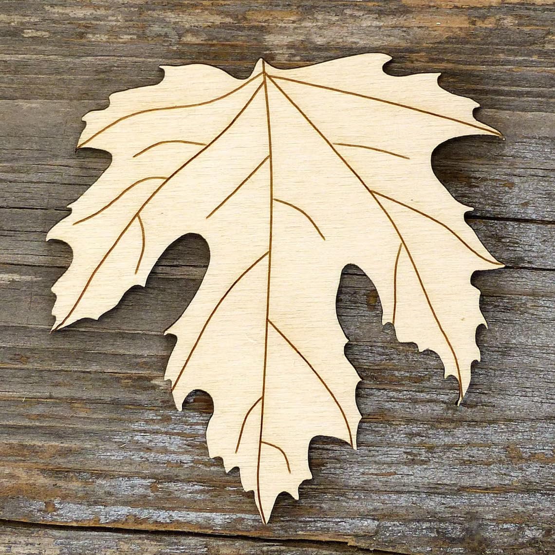 Wooden leaf cutout on a wooden surface