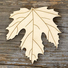 Wooden leaf cutout on a wooden surface