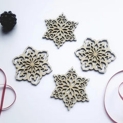 Four decorative snowflake-shaped cutouts on a white background