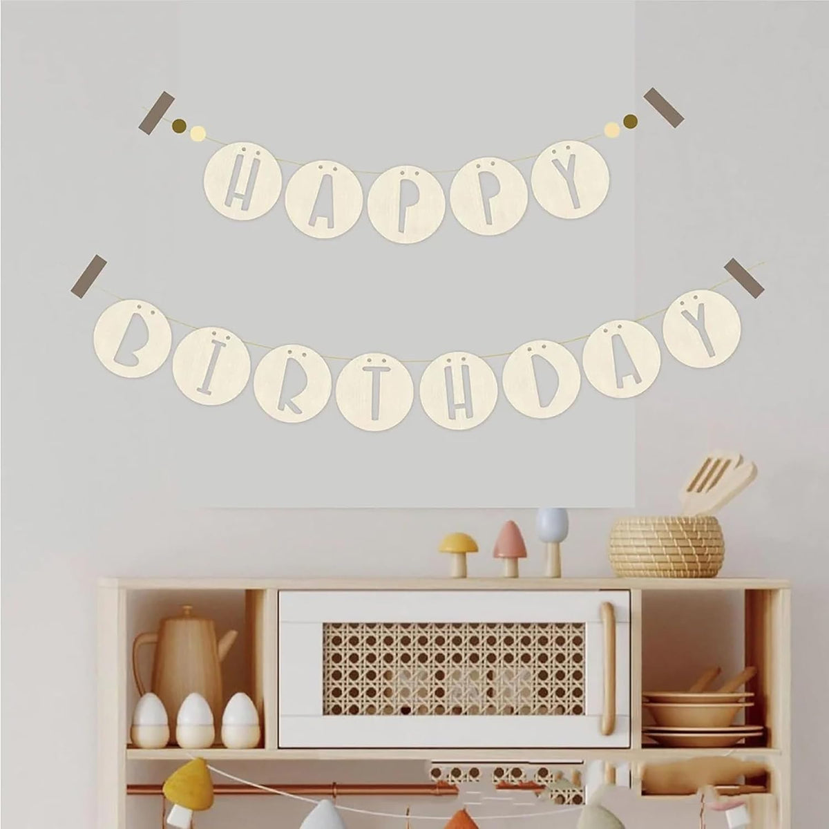 Happy Birthday banner on a wall above a shelf with decorative items.