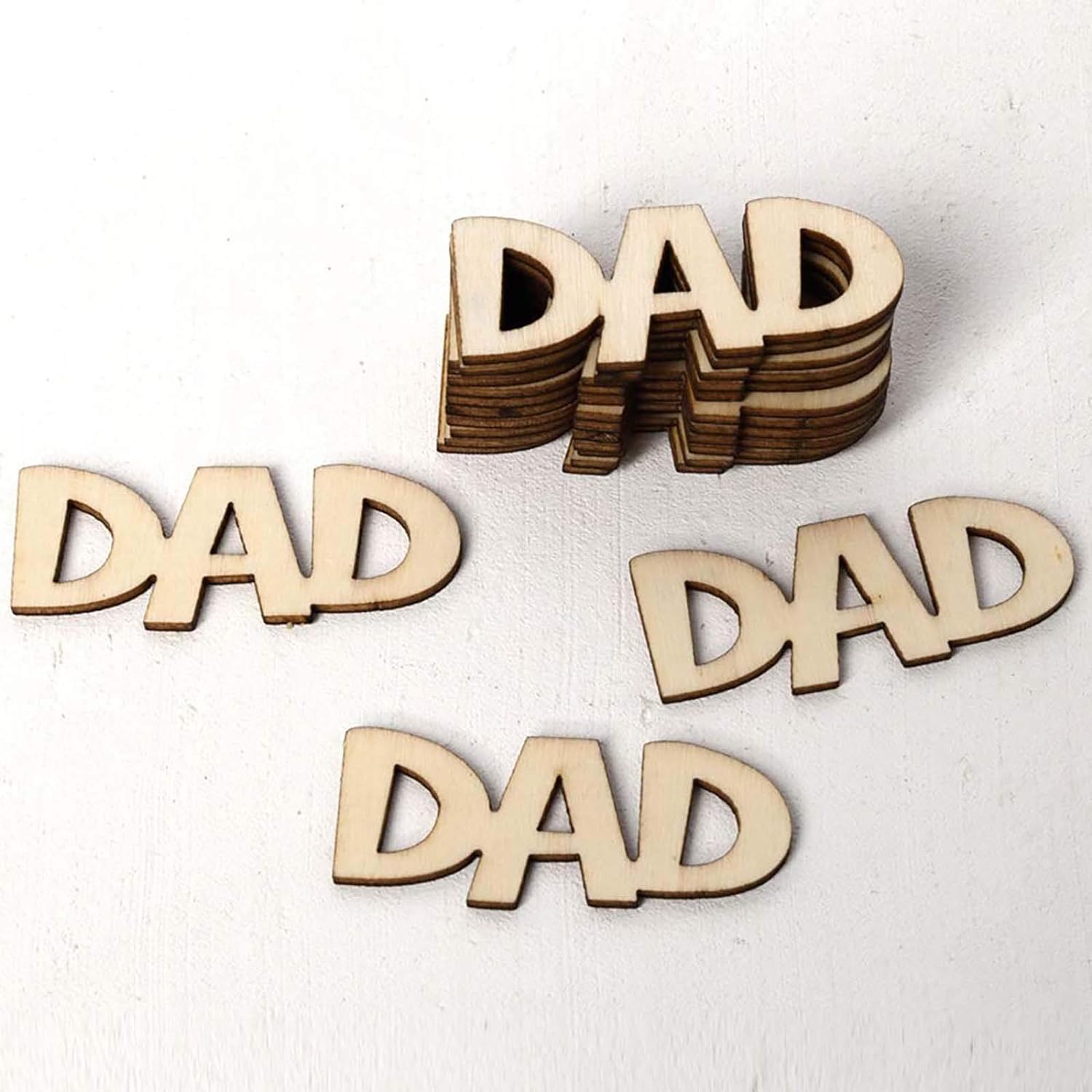 Wooden letters spelling 'DAD' on a white background