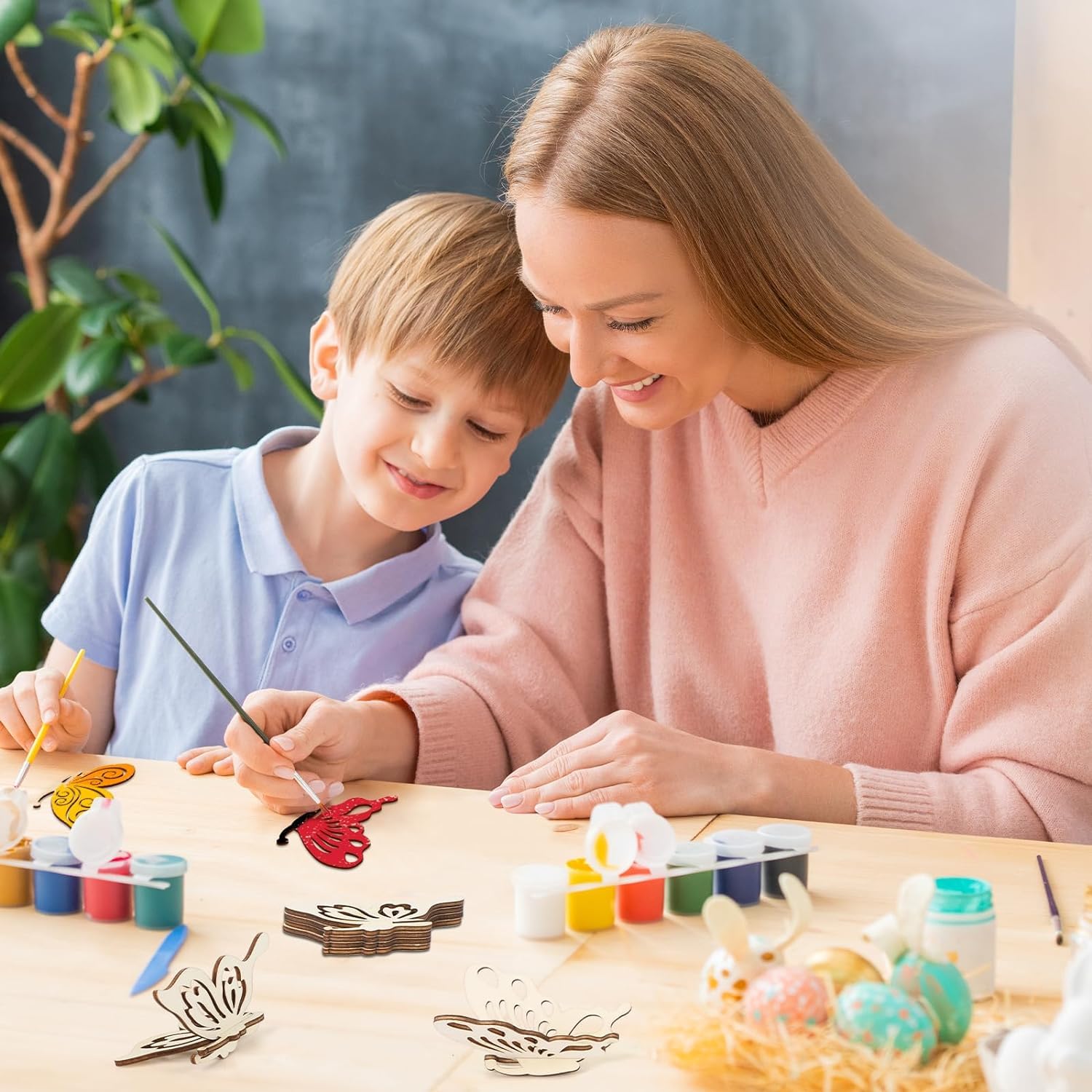 Woman and child painting with watercolors at a table