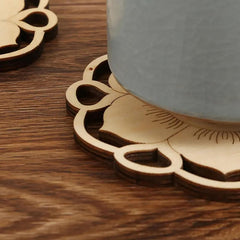 Wooden coaster with floral design on a wooden surface