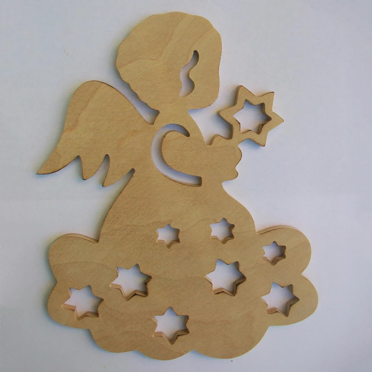 Wooden angel cutout with star shapes on a white background