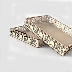 Decorative gold tray with intricate patterns on a white background