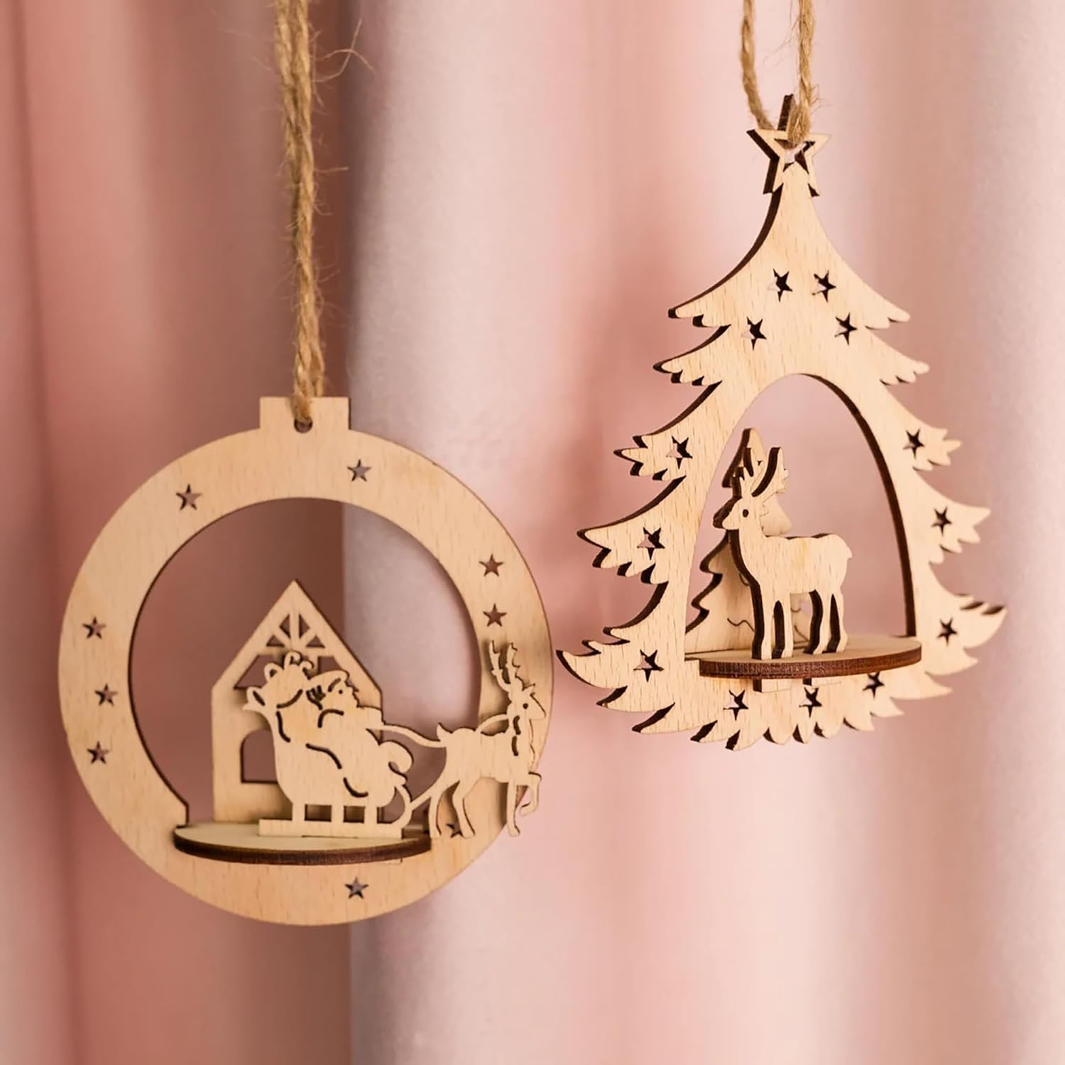 Two wooden Christmas ornaments on a pink background