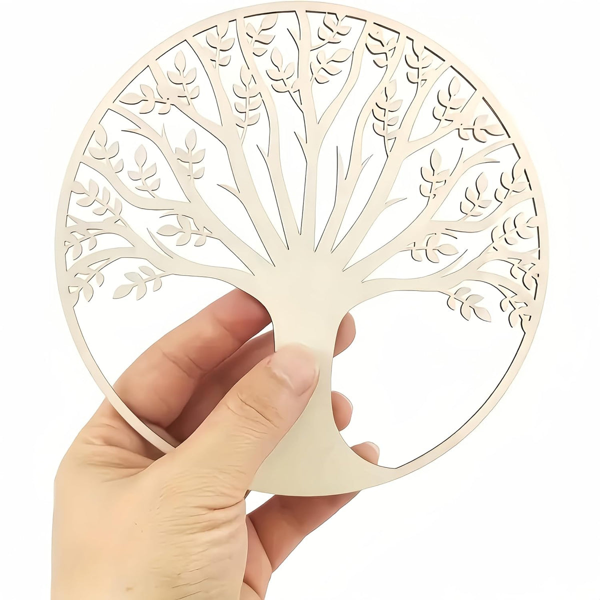 Hand holding a beige tree-shaped cutout against a white background