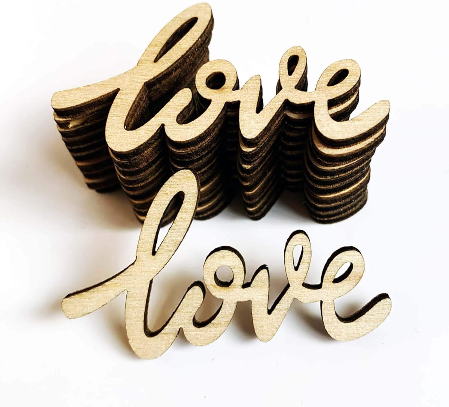 Wooden 'love' word cutouts on a white background